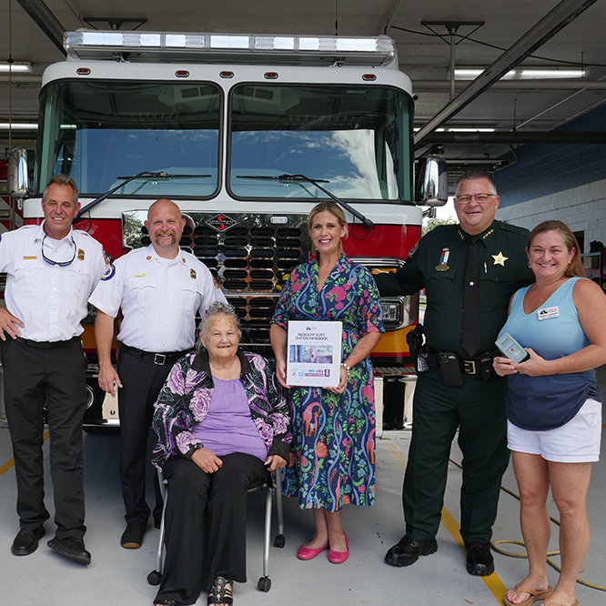 Fire rescue, Brevard Sheriff Wayne Ivey and SPCA of Melbourne and Brevard Kennel Club take photo with pet microchip scanner